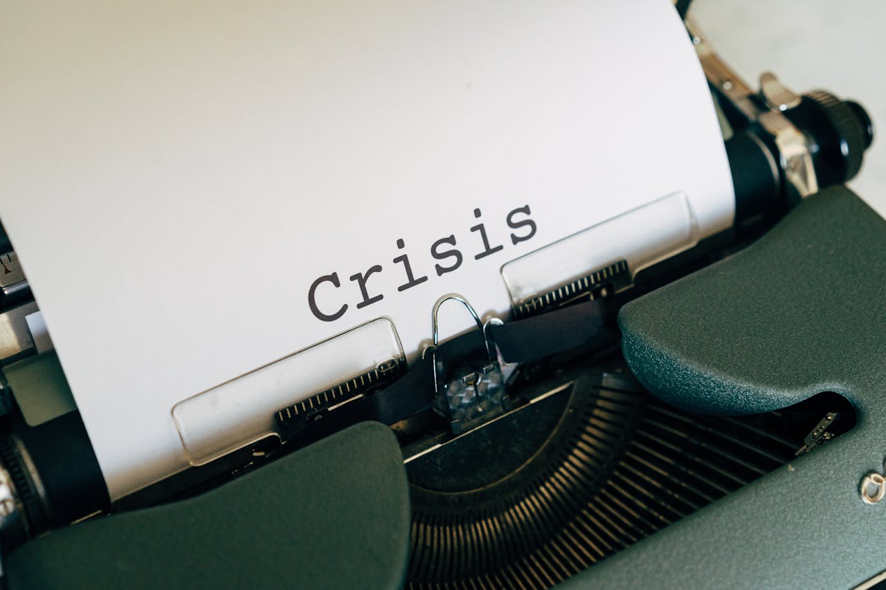 home-services-004 Close-up of a vintage typewriter with the word Crisis typed on paper.