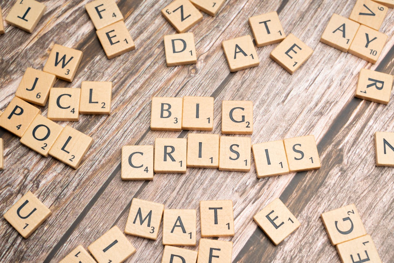 home-hero-bg Wooden tiles forming the words Big Crisis on a wooden background.